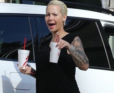 Amber Rose finally shows off smaller boobs as she makes first appearance after breast reduction surgery ( Photos)