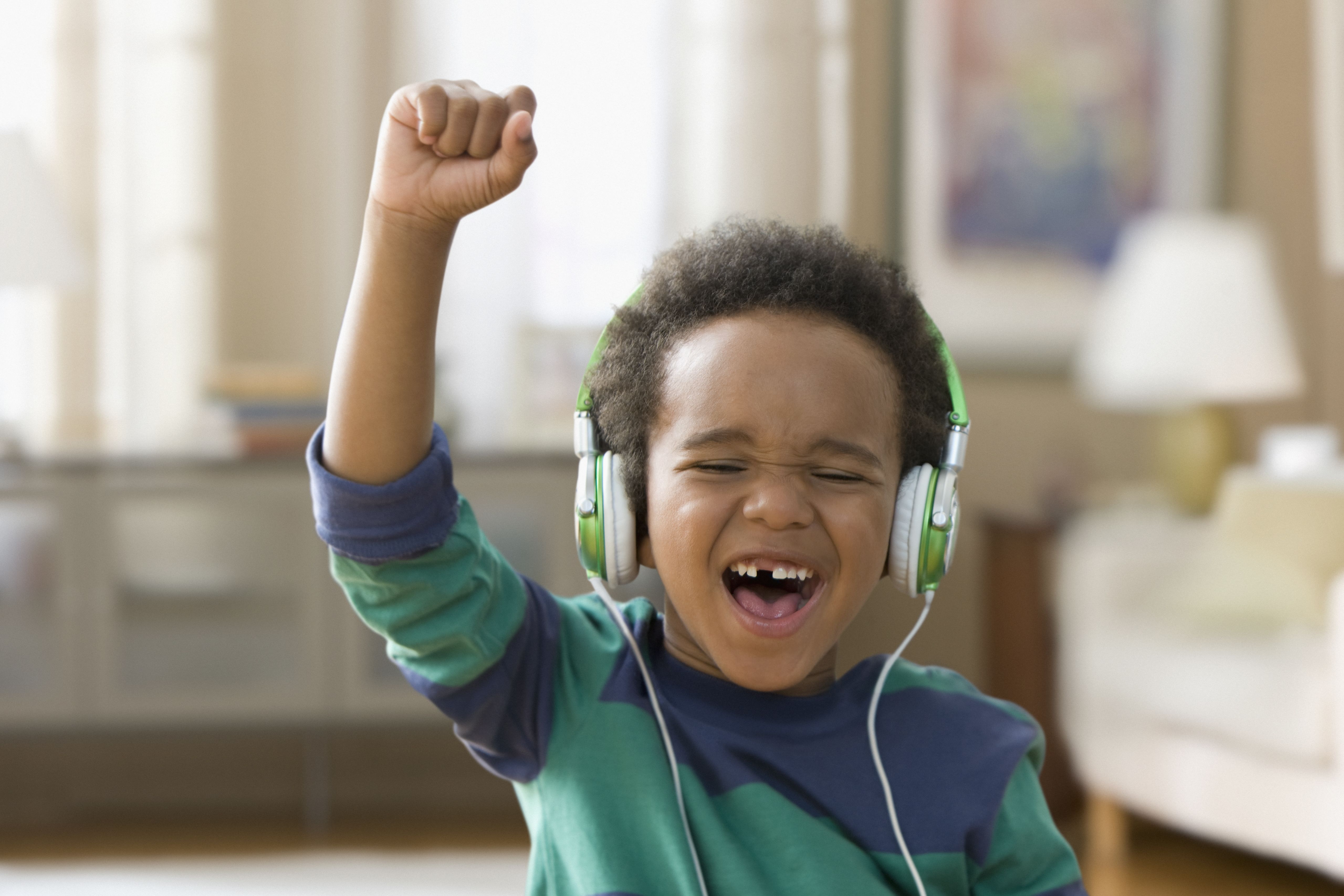 A child listening to music on headphones. 