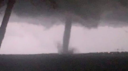 This Oct. 20, 2019 image made from video by Twitter user @AthenaRising shows the tornado in Rockwall, TX. The National Weather Service confirmed a tornado touched down in Dallas on Sunday night, causing structural damage and knocking out electricity to thousands.