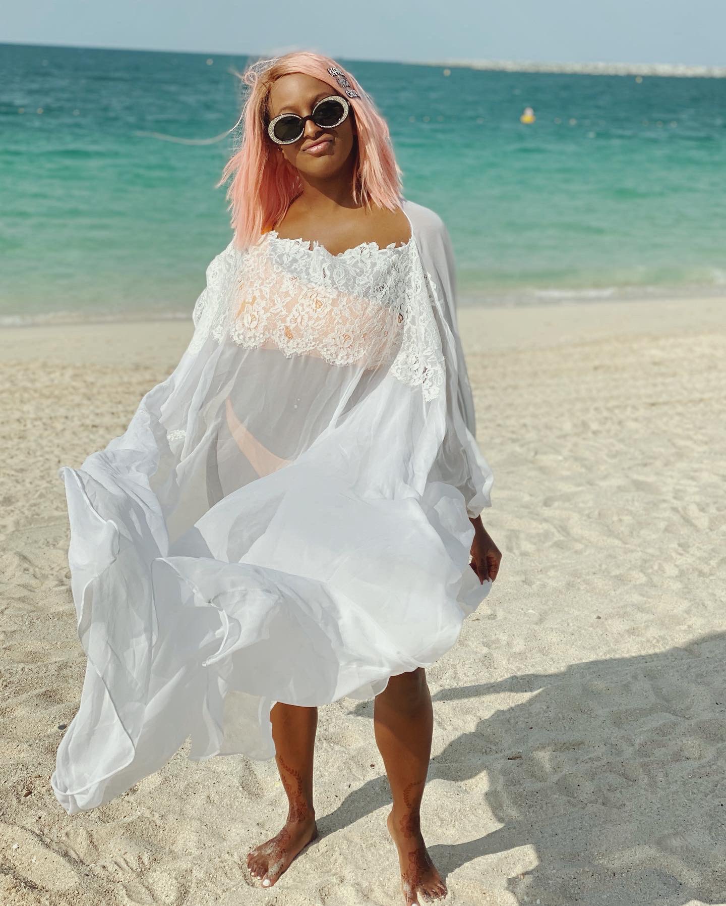 Beautiful photos of dj Cuppy by the beach