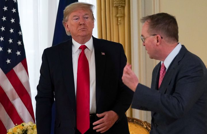 President Donald Trump looks at Acting White House Chief of Staff Mick Mulvaney during a meeting in December.