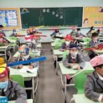 students wear social distancing headgears to class as schools resume in china photos