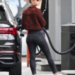 mia goth in black jeans at a gas station in los angeles