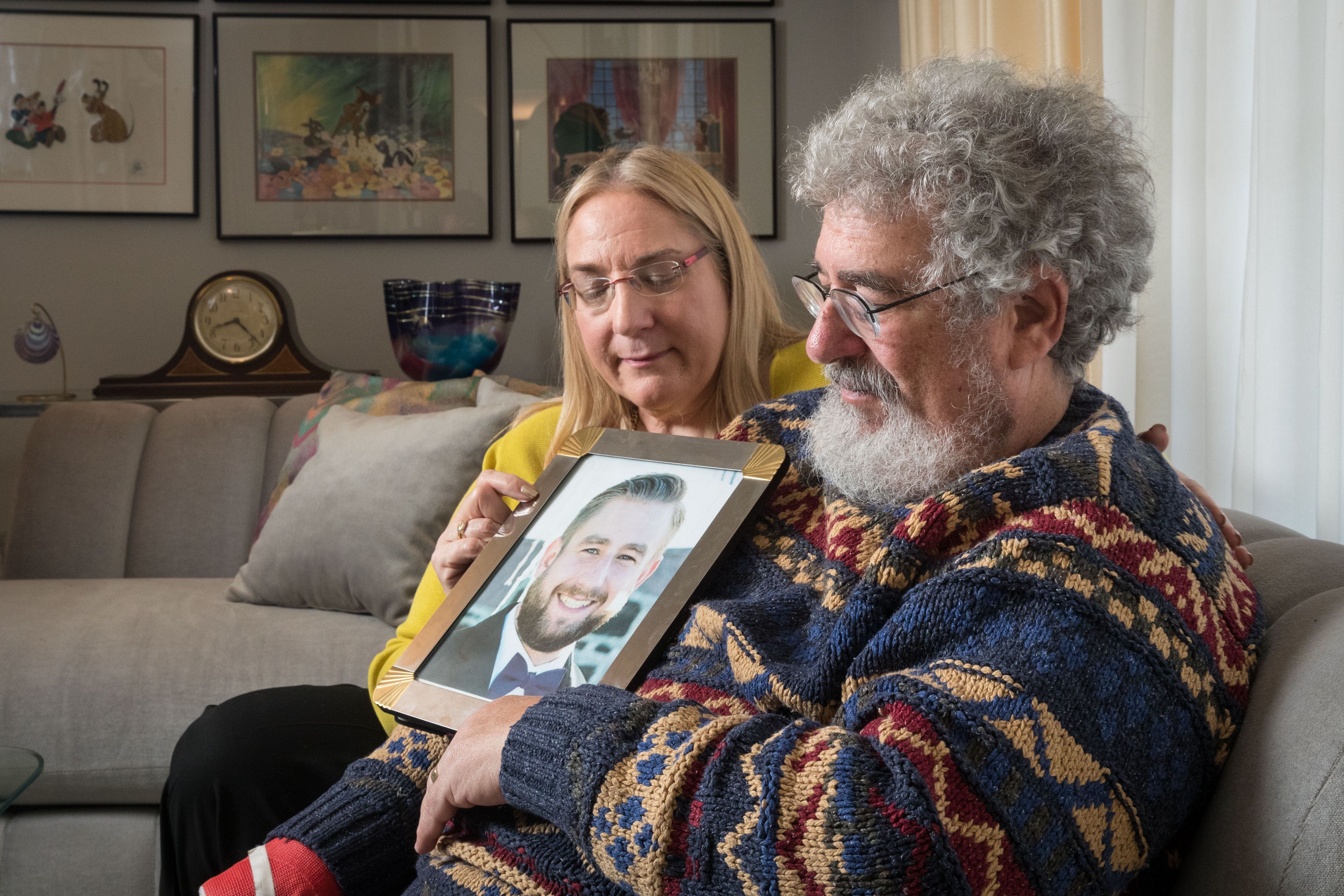 Mary Rich and her husband, Joel Rich hold a photo of their son in their home in Omaha, Nebraska, on Jan. 11, 2017.