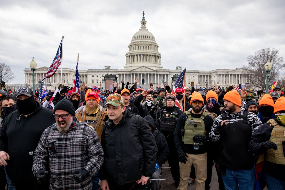 Members of the Proud Boys make a hand gesture while walking near the U.S. Capitol on Jan. 6.