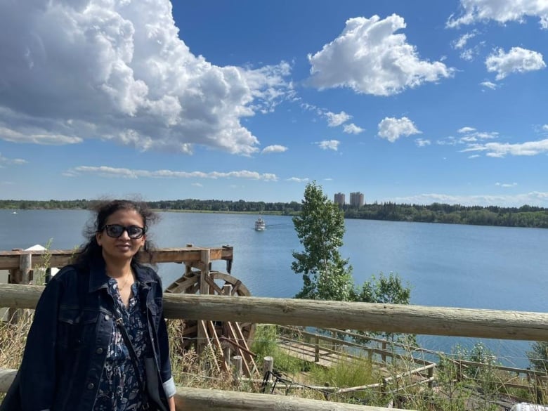 A woman stands near the Glenmore reservoir in Calgary.