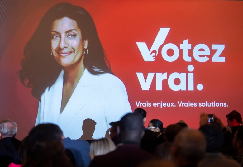 A photograph of Quebec Liberal Party leader Dominique Anglade is shown on a screen next to their upcoming election campaign slogan.