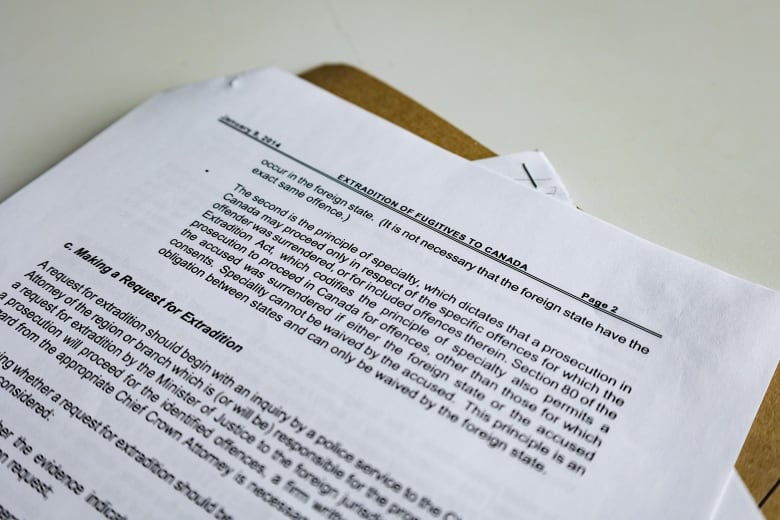 A piece of paper outlines aspects of the extradition process