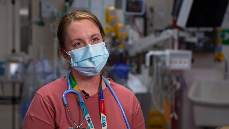 Woman wearing a stethoscope and SickKids lanyard around her neck.