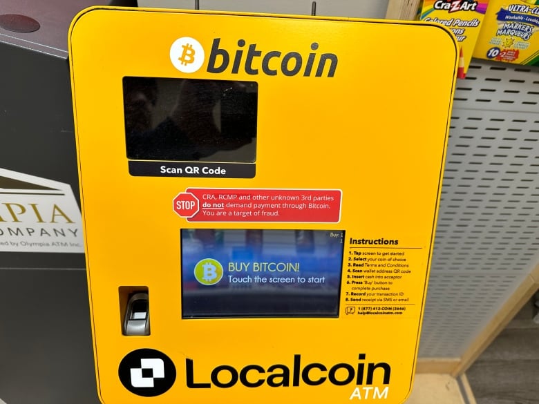A bitcoin ATM sign warns that users could be fraud targets.