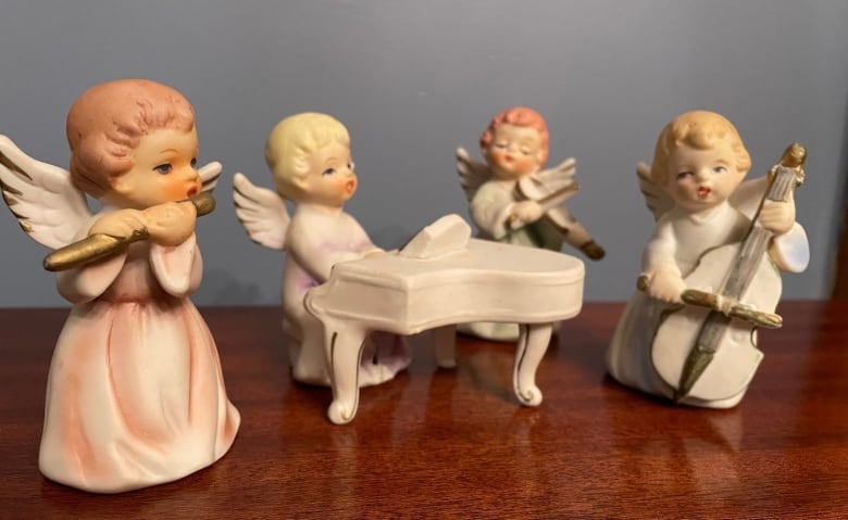 A set of four porcelain angels each playing a unique musical instrument. 
