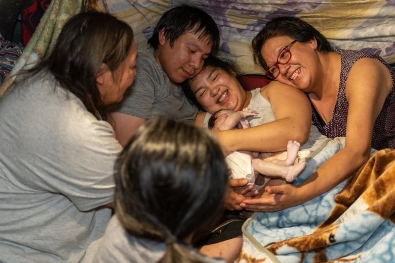 Parents Wesley and Hannah Bearskin, centre, in moments after Koa's birth. Hannah's mom, Rose Duff, right. "It was the most amazing experience to see one of my grandchildren come into this world like it used to be done long ago," said Duff. 