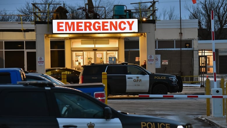 Police cars are seen outside an emergency department.