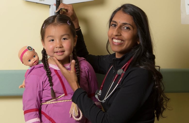 Dr. Radha Jetty poses with a young girl in a medical office in a photo supplied by CHEO, the children's hospital in Ottawa that serves eastern Ontario, western Quebec and western Nunavut.