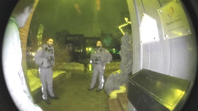 two bylaw officers seen from a doorbell camera
