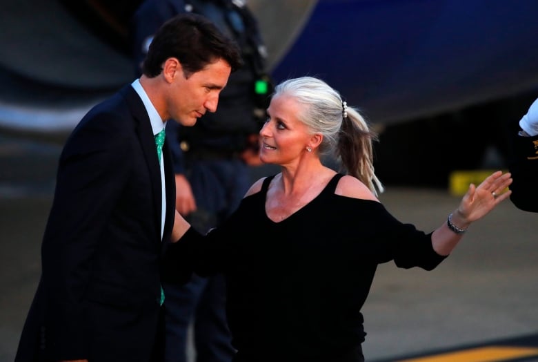 Prime Minister Justin Trudeau is greeted by Isabelle Hudon, the Canadian ambassador to France, upon his arrival at the airport in Biarritz, France on Aug. 23, 2019. Trudeau is joining U.S. President Donald Trump, host French President Emmanuel Macron and the leaders of Britain, Germany, Japan and Italy for the annual G-7 summit in the elegant resort town of Biarritz.