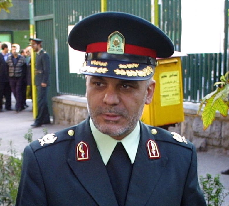 A man wearing a military dress uniform is shown.