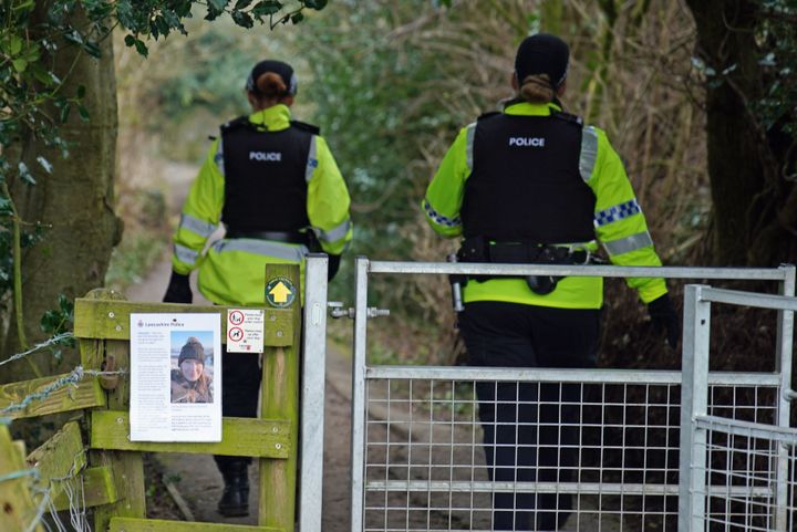 Police officers walk along a footpath in St Michael's on Wyre, Lancashire, as they continue their search for Bulley