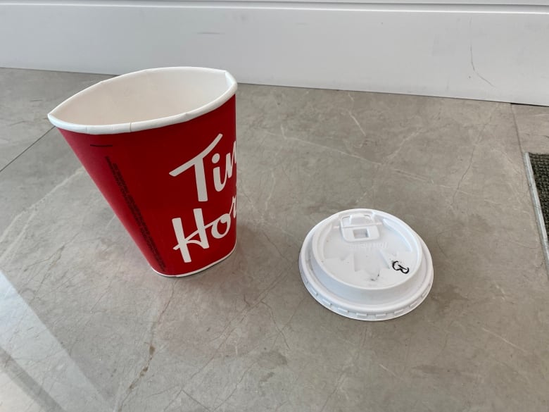 A crumpled Tim Hortons paper coffee cup.