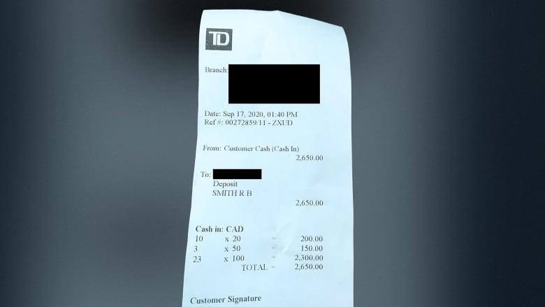 A paper receipt shows a deposit made at a TD Bank in the sum of $2,650.