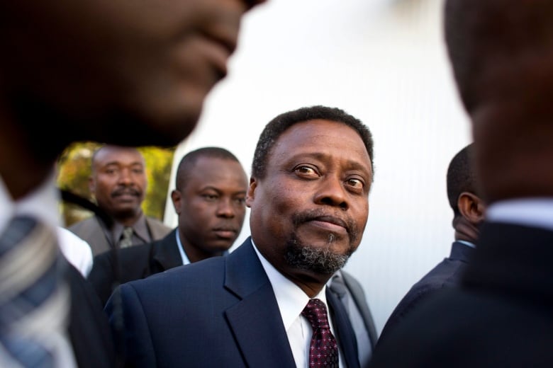 Haiti's new interim Prime Minister Fritz Jean arrives for his induction ceremony at the National Palace in Port-au-Prince, Haiti, Friday, Feb. 26, 2016. Jean, an economist and former governor of Haiti's central bank, joins the interim government which is expected to last 120 days as it prepares to hold a postponed runoff election on April 24.