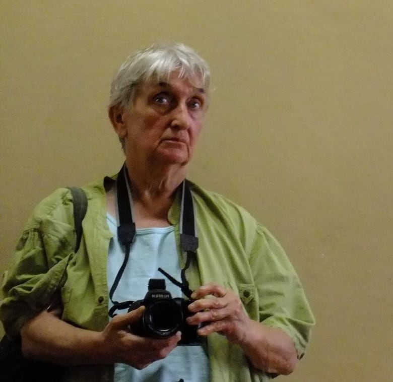 Older woman holding camera