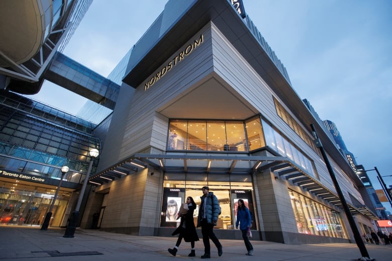 Shoppers walk past a Nordstrom store in Toronto