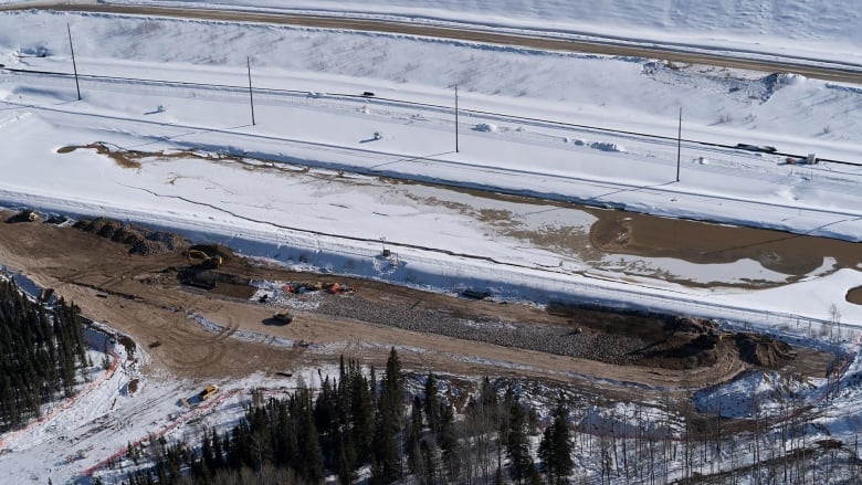 Constructions crew work on a dirt site where wastewater leaked at Kearl Oil sands.