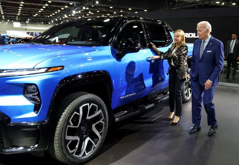 U.S. President Joe Biden is shown a Chevrolet Silverado EV by General Motors CEO Mary Barra during a visit to the Detroit auto show to highlight electric vehicle manufacturing in America, in Detroit, Michigan, U.S., Sept. 14, 2022. 