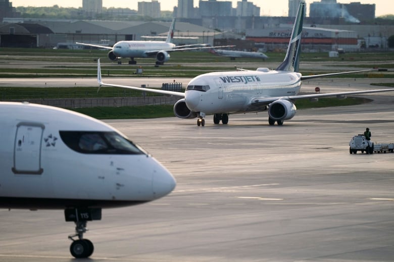 Several airliners are seen on the tarmac of an airport. 