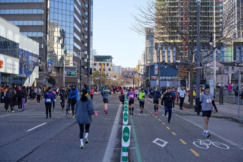 The view from the downtown streets, with runners in both sides of the streets. 