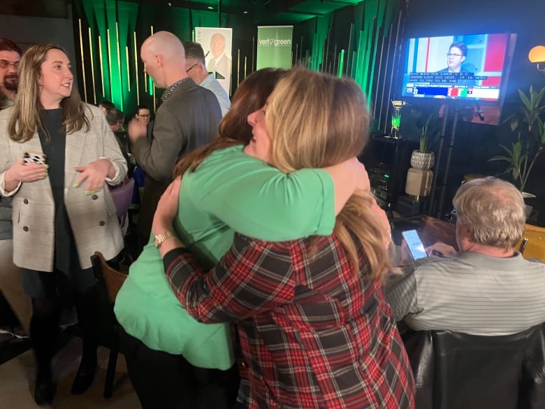 Green Karla Bernard embraces Liberal candidate Barb MacLeod. The two were running against each other in District 12: Charlottetown-Victoria Park.