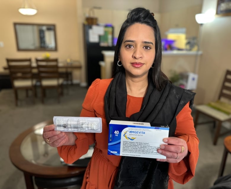 Alberta resident Sophia Khan, who had a portion of her intestines surgically removed to combat Crohn's disease, holds up the biosimilar drug she was switched to two years ago.