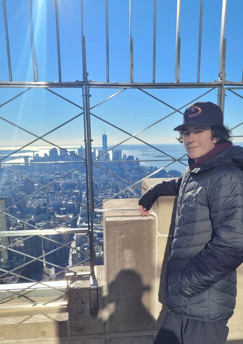 Harrison Gilks stands at top of Empire State Building. 