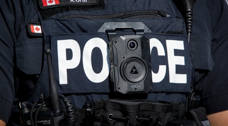 A Toronto police officer displays a body worn camera.