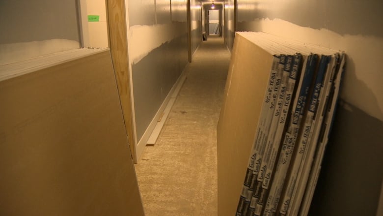 A hallway is shown with construction underway. 