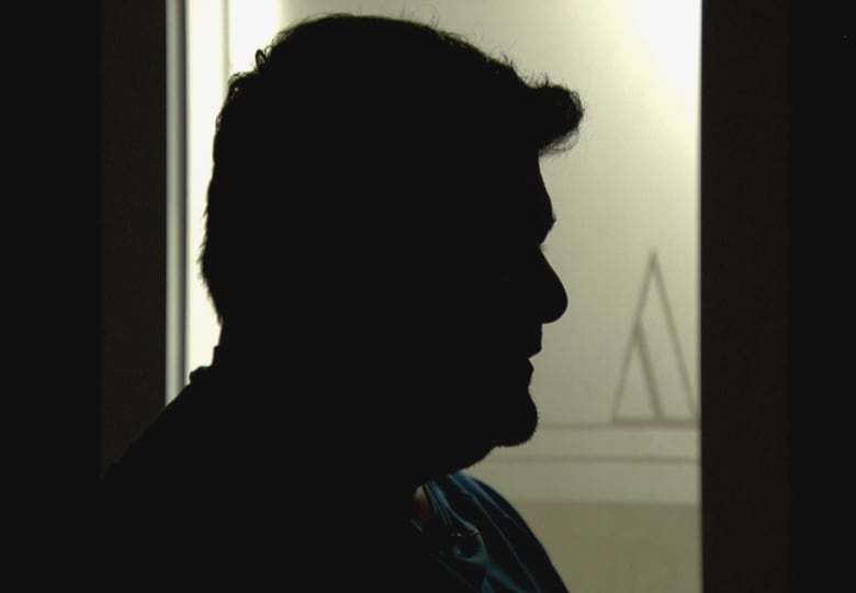 Man pictured in silhouette 