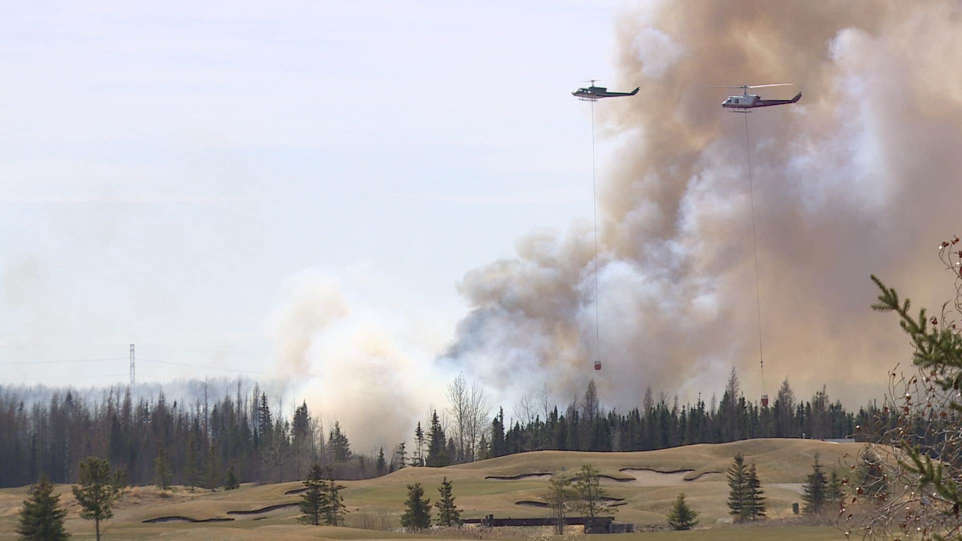 out of control wildfires force thousands more albertans to flee