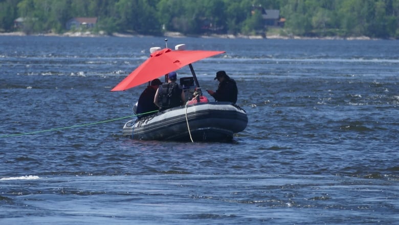 RCMP are shown on a boat in the middle of a body of water.