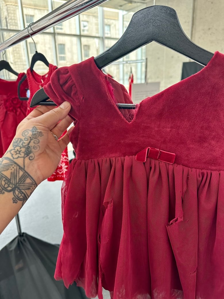Torn and dirty, red baby dress.