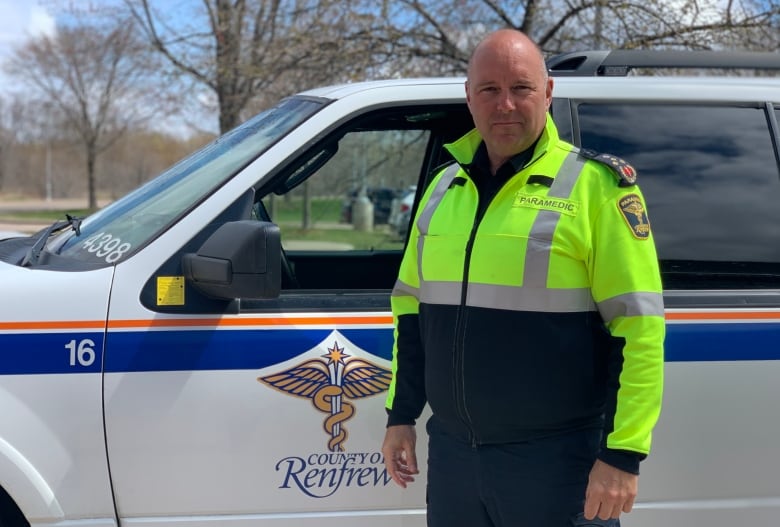 paramedic chief michael nolan stands in front of his paramedic vehicle