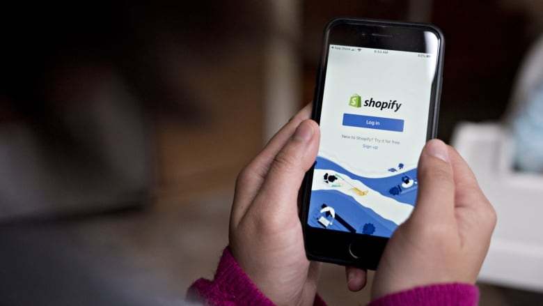 shopify's logo is shown on a cellphone app