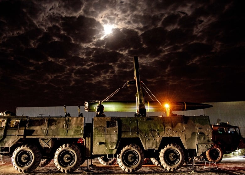 A mobile missile launcher at night.