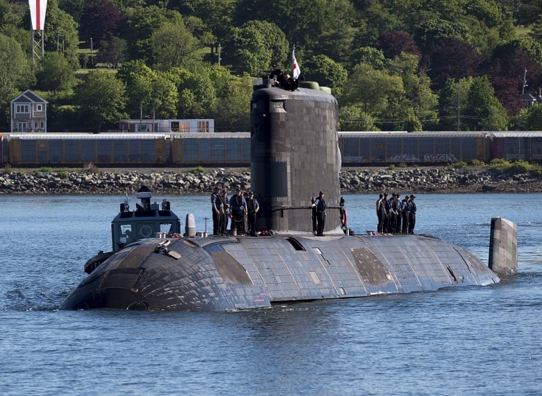 A submarine returns to port.