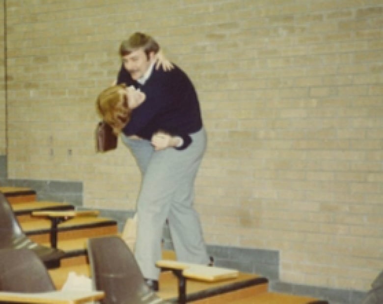 teacher dipping a student like a dance move inside a college classroom