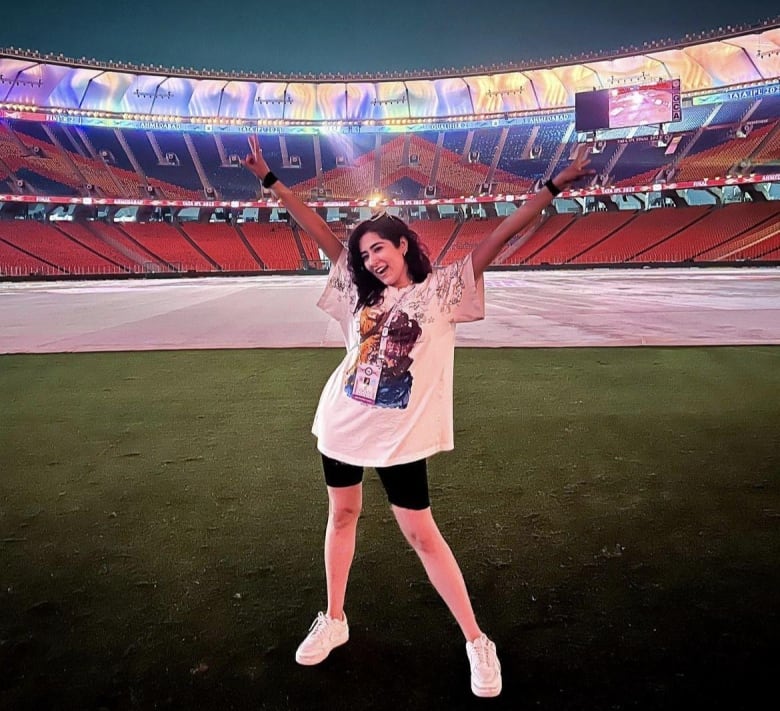 A woman posing in a stadium 