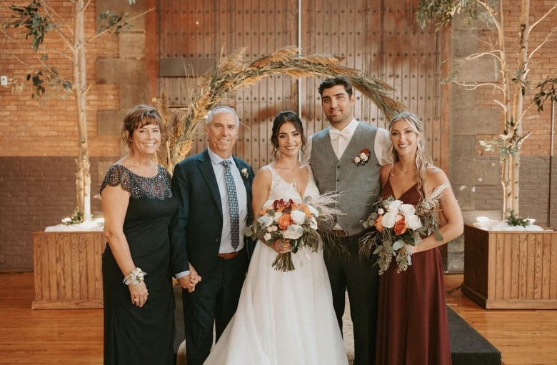 Victoria Baertsoen, right, is shown at her sister Alicia's wedding. Her father, Chris, and mother, Kerry, left, are pictured.
