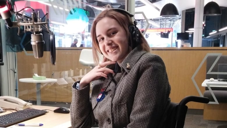A smiling teenager in a radio studio.