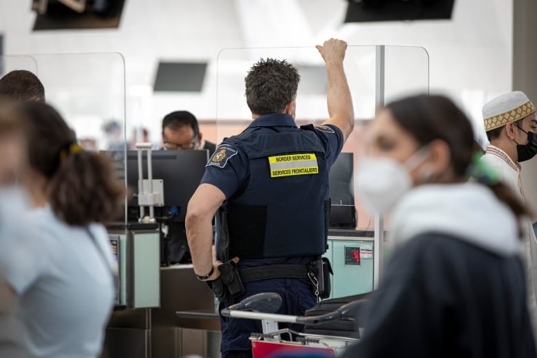 Canada Border Services Agency workers at Pearson International Airport in Toronto.