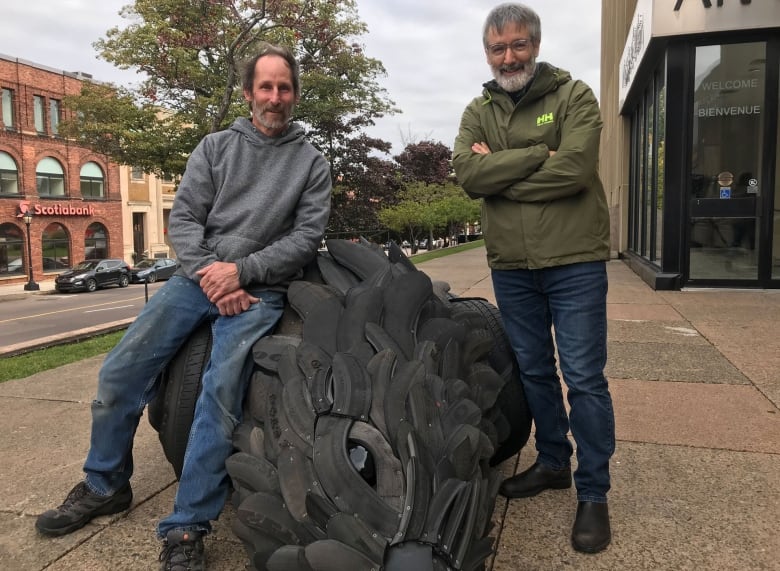 Gerald Beaulieu, left, and Confederation Centre Art Gallery director Kevin Rice pose with the crow sculpture when it debuted in 2018.